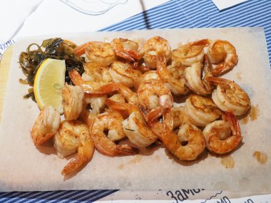 Tavada pişirilmiş midye ve karides.