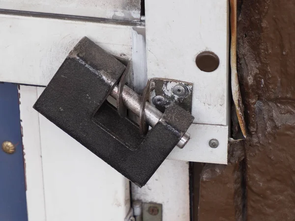 old metal lock on a plastic door