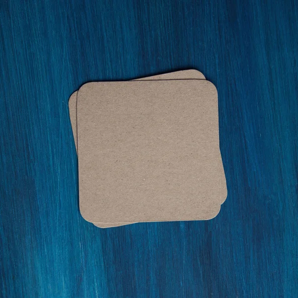 Empty blank cardboard beermat on wood mockup — Stock Photo, Image