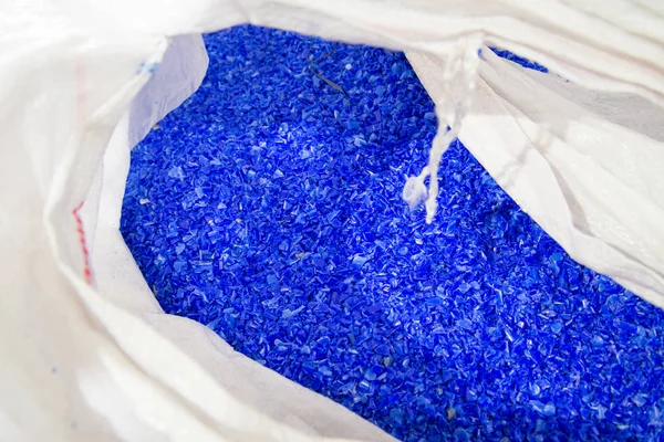 Blue plastic polymer pellets in the bag — Stock Photo, Image