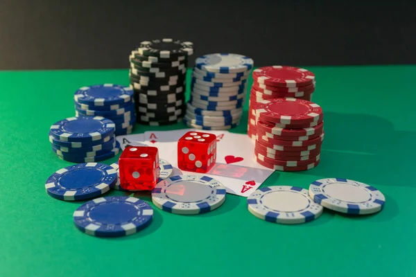 Cards, dice and poker chips on a green table — Stock Photo, Image