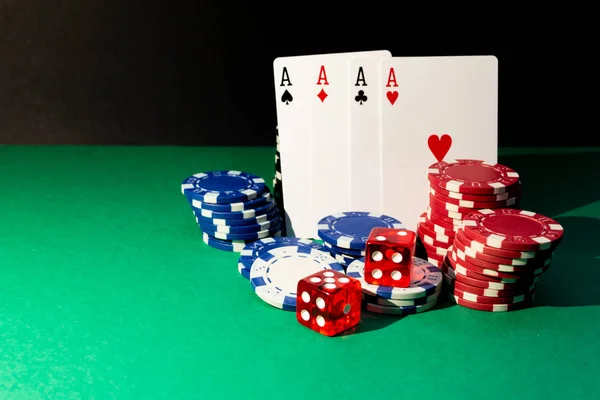 Cards, dice and poker chips on a green table — Stock Photo, Image