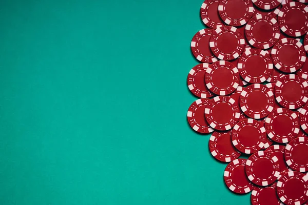 Group of red poker chips on a turquoise board — Stock Photo, Image