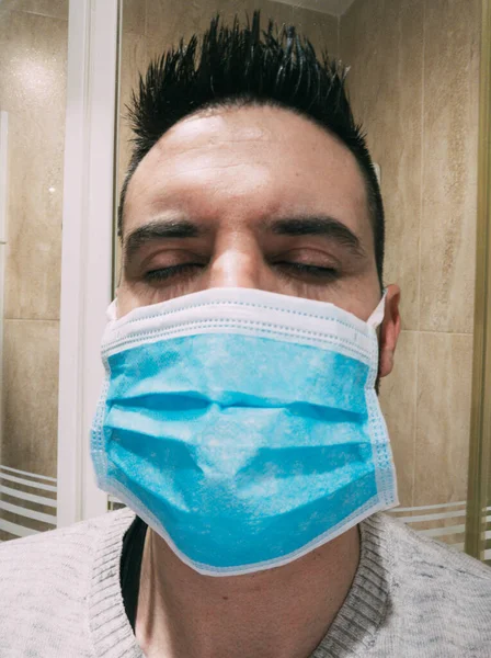 The new coronavirus of Wuhan (2019-nCoV), young man with blue medical mask — Stock Photo, Image