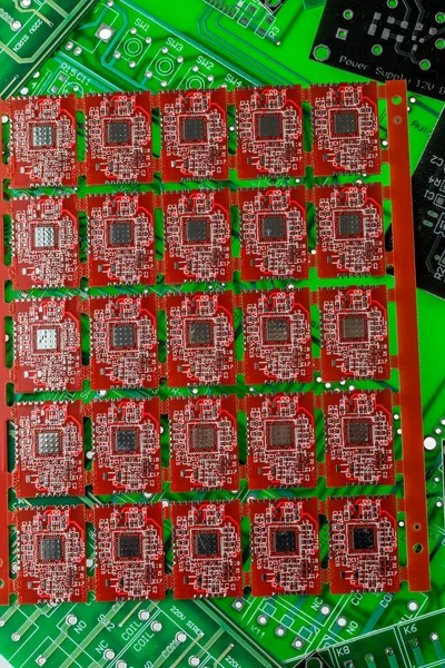 Pile of green, red and black printed circuit borads on top of each other