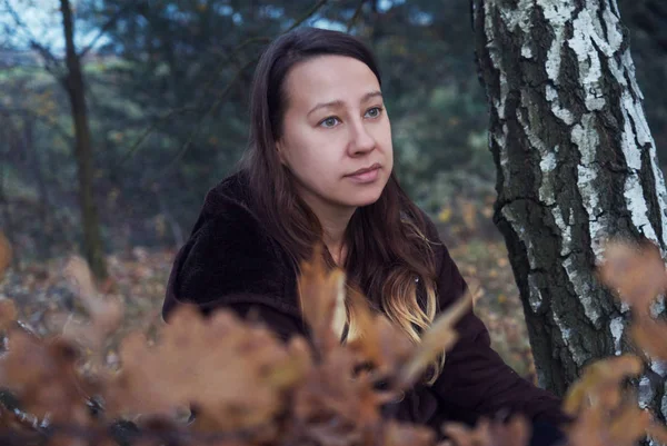 White woman in the forest, autumn, sunset.