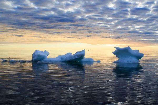 Ice in sea water against the sunset sky — Stock Photo, Image