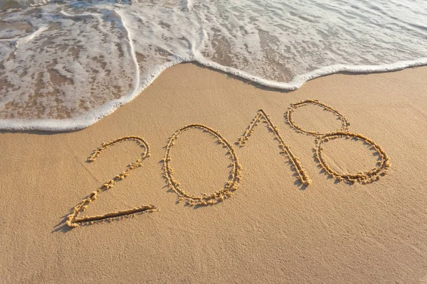 Digit 2018 on beautiful beach at sunset — Stock Photo, Image