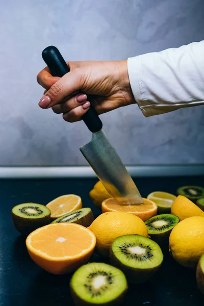 man cutting fruit in the kitchen