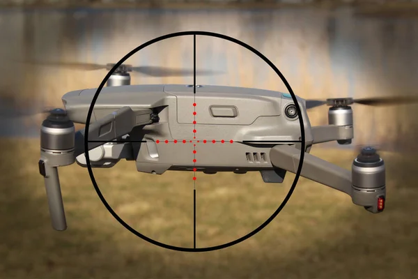 Flying drone in the sight of an electronic gun, flight ban, safety.