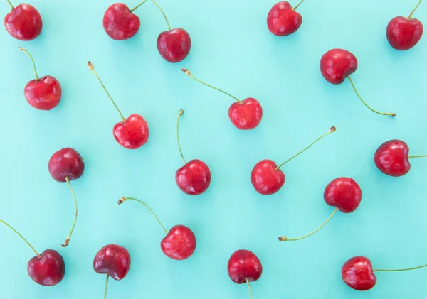 Sweet cherries on blue — Stock Photo, Image