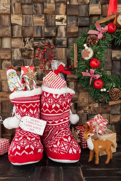Little knitted boots with presents — Stock Photo, Image