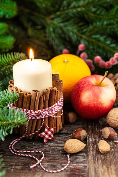 Burning candle and pine branches — Stock Photo, Image