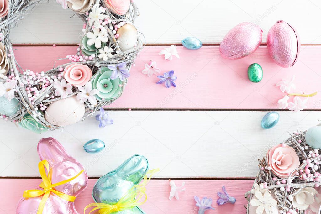Coloful decorations on a white and pink background for a Happy Easter