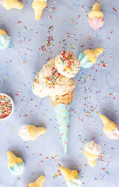 Scoops of vanilla ice cream with rainbow sprinkles
