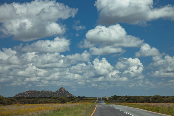 South African road through the savannas and deserts with marking