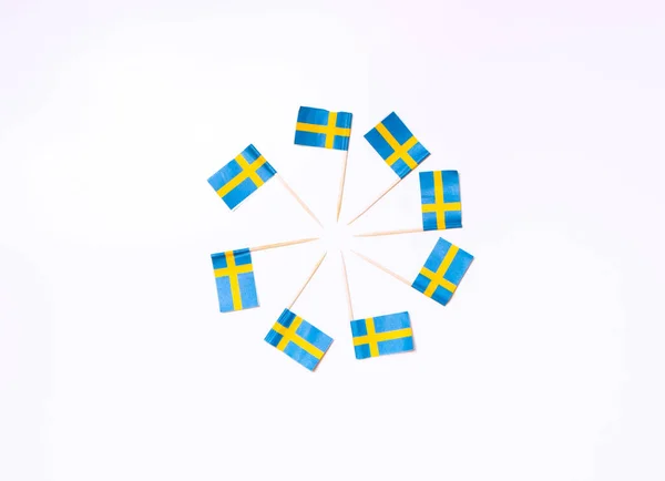 Swedish flags in the shape of circle on the white background. Swedish flag concept. Scandinavian pattern.
