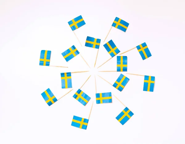 Swedish flags in the shape of two circles on the white background. Swedish flag concept. Scandinavian pattern.