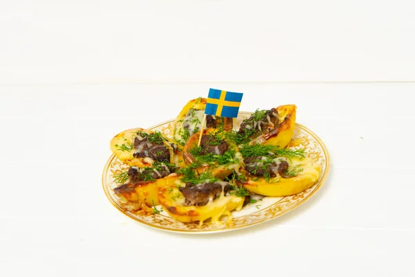 Stuffed potatoes. Swedish flag. Potatoes, minced meat, onion, carrot, cheese, garlic, dill. Swedish cuisine. Scandinavian food. Background with place for text.