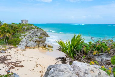 Ruins of ancient Tulum. Architecture of ancient maya. View with sea. Blue sky and lush greenery of nature. travel photo. Wallpaper or background. Yucatan. Mexico.