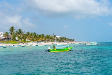 Puerto Morelos deniz manzaralı ve tekneli. Bulutlu Karayip gökyüzü. Beyaz kum kıyısı. Arkaplan ya da duvar kağıdı. Yucatan. Quintana Roo. Meksika mı? Riviera maya.