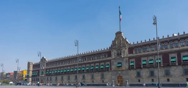 National Palace in Zocalo square Mexico city. Architecture, travel photo. View with blue sky. Background or wallpaper.