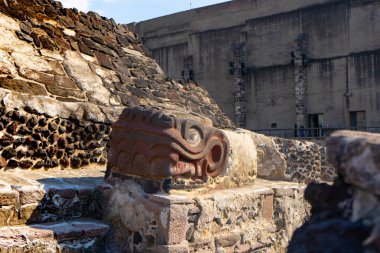 Fragment of Greater Temple (Templo Mayor) with Kukulkan (Feathered Serpent) head. Detail of ancient aztec ruins. Travel photo. Mexico city. clipart