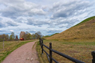Royal Mounds (Kungshogarna) Gamla Uppsala 'da bulunan üç büyük el arabası. Stockholm yakınlarında İsveç 'te arkeolojik alan.