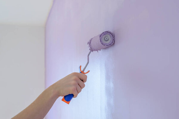 roller painting the wall close-up