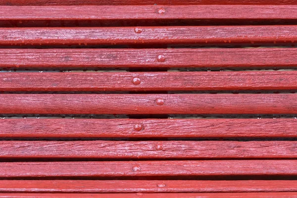 Red wooden bench close-up — Stock Photo, Image