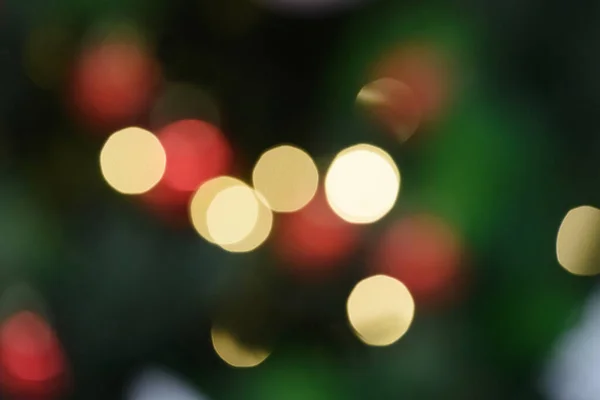 Multicolored christmas bokeh on a dark background — Stock Photo, Image