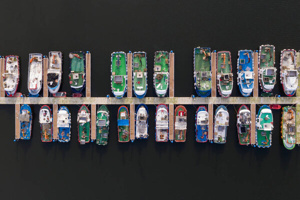 Fishing boats on the pier in the port aerial view — Stock Photo, Image