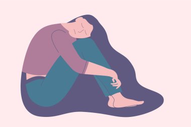 Depresyonda ya da üzgün kız tuğla duvarın yanında oturuyor..