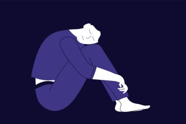 Üzgün ya da üzgün kız tuğla duvarda oturuyor.