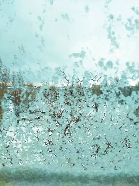 Melting and wet snow on the window. Background Screensaver