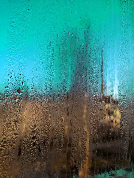 Rainy day through window. Rain on window. Rain drops on widow glass