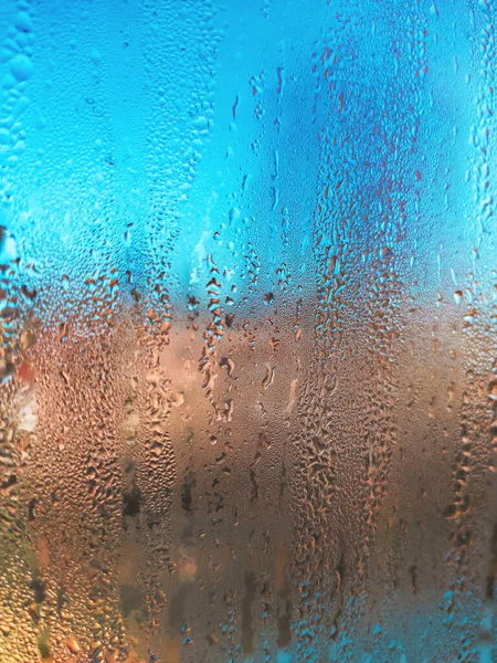 Rainy day through window. Rain on window. Rain drops on widow glass. Rain.