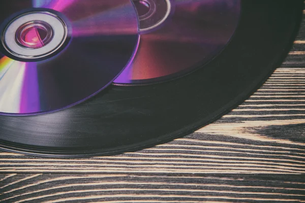 Morden ve eski ahşap masa üzerindeki ses diskleri — Stok fotoğraf
