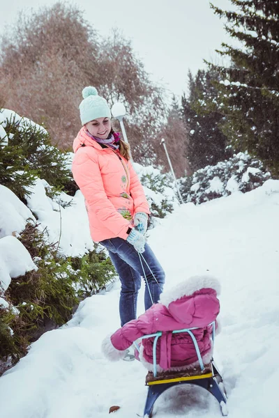 Happy family mother and baby girl daughter in winter outdoors — Stock Photo, Image