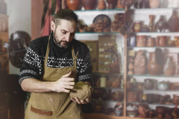 Adult male potter master mashing the clay — Stock Photo, Image