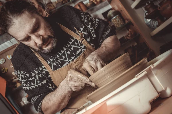 Elderly man making pot using pottery wheel in studio — Stock Photo, Image