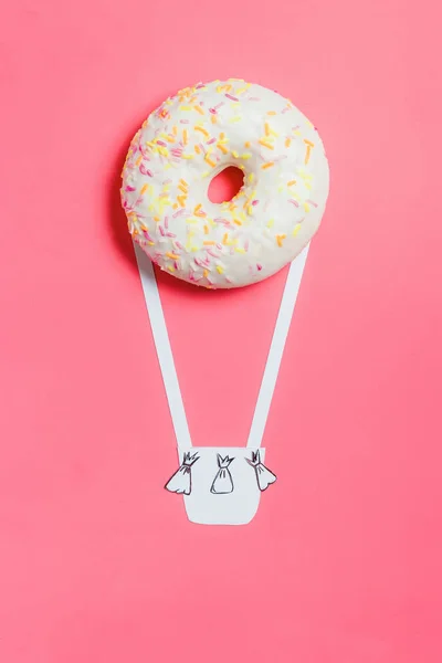 Donut op roze, creatieve voedsel minimalisme, Donut in de vorm van Aerostat in de hemel met wolken, bovenaanzicht met kopie ruimte, afgezwakt — Stockfoto