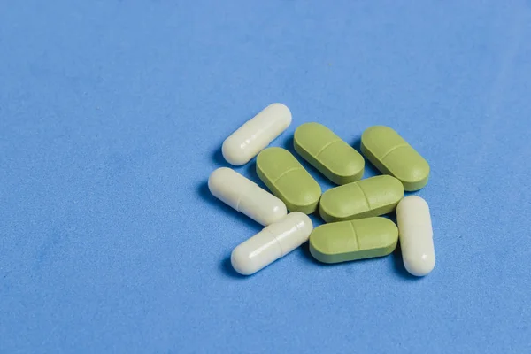 Assortment of Pills, Tablets and Capsules on Blue Table. — Stock Photo, Image