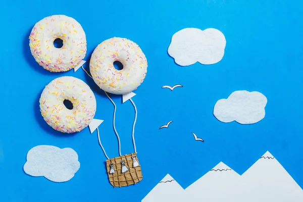 Creative Food Minimalism, Donut in Shape of Aerostat in Blue Sky with Clouds, Mountains, Top View, Copy Space, Travel