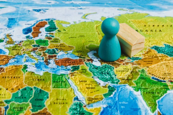 Travelling Concepts. Traveler Miniature Mini Figures Standing on World Map.