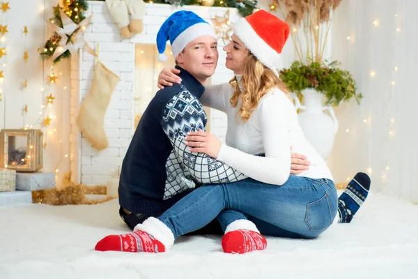 Beautiful young couple in love have fun on Christmas background. — Stock Photo, Image