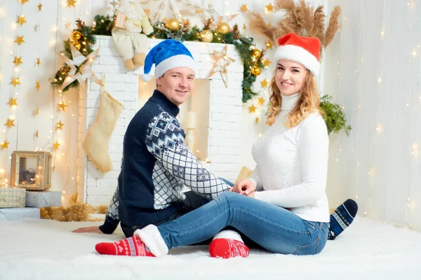 Beautiful young couple in love have fun on Christmas background. — Stock Photo, Image
