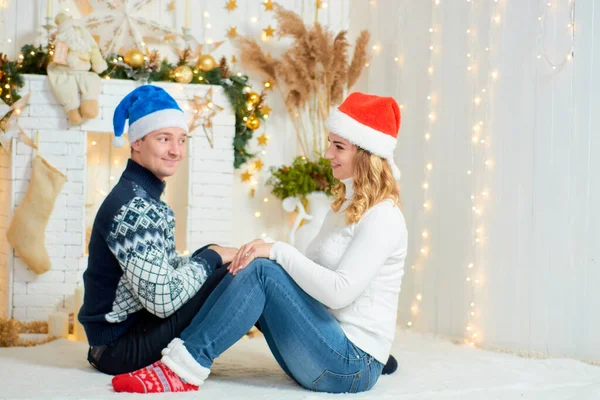 Beautiful young couple in love have fun on Christmas background. — Stock Photo, Image