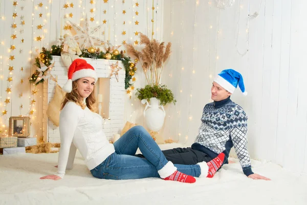 Beautiful young couple in love have fun on Christmas background. — Stock Photo, Image