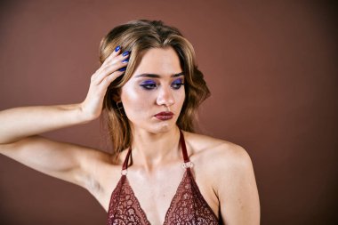 Güzel genç bir kadın portreye bakıyor. Temiz ciltli, model bir kız..